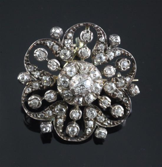 An Edwardian gold, silver and diamond cluster flower head pendant brooch, 28mm.